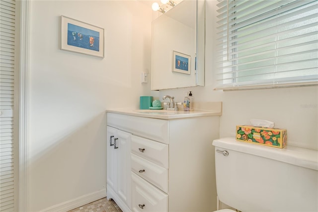 bathroom featuring toilet and vanity