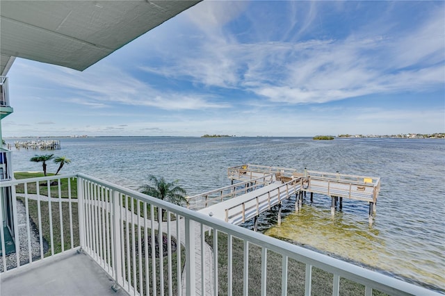 exterior space featuring a balcony and a water view