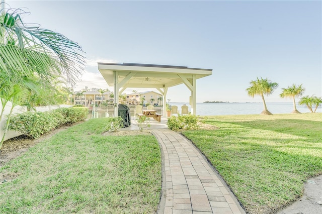 view of yard featuring a water view and a patio area