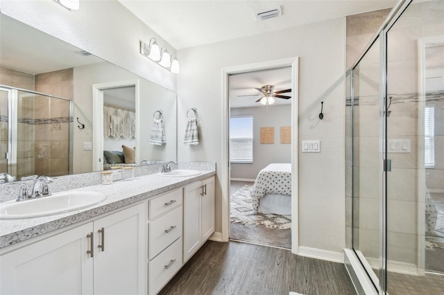 bathroom with an enclosed shower, vanity, hardwood / wood-style floors, and ceiling fan