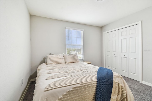 bedroom featuring a closet and dark colored carpet