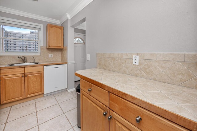 kitchen featuring dishwasher, tile countertops, decorative backsplash, sink, and ornamental molding