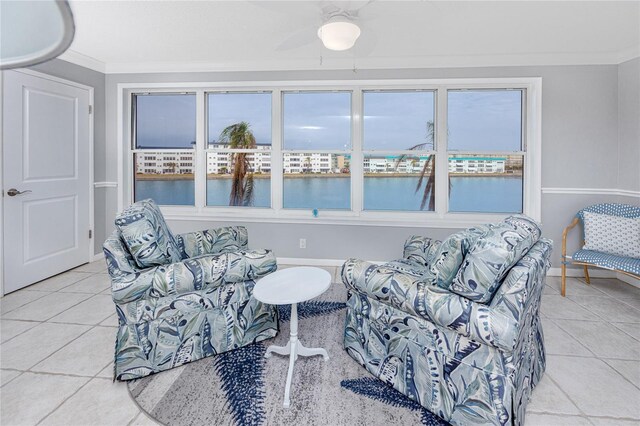 living area featuring crown molding and light tile patterned flooring