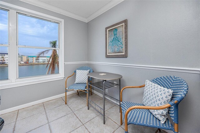 sitting room featuring a water view and ornamental molding