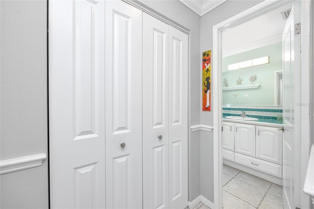 interior space featuring sink and ornamental molding