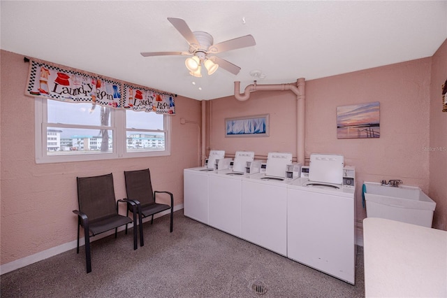 washroom featuring ceiling fan, washer and clothes dryer, light carpet, and sink