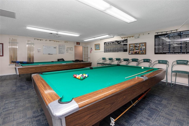 recreation room with pool table and a textured ceiling