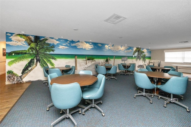 dining area with carpet floors and a textured ceiling