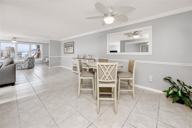 dining space with ceiling fan, light tile patterned floors, and crown molding