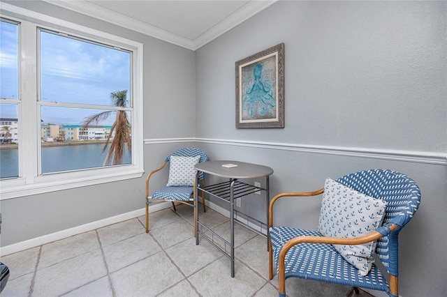 living area with a water view and ornamental molding