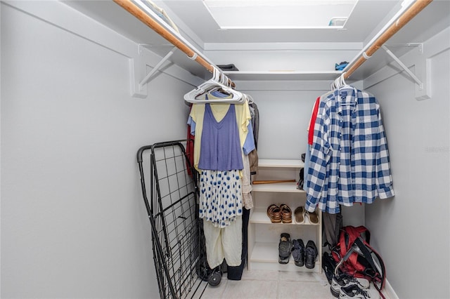 spacious closet with light tile patterned floors