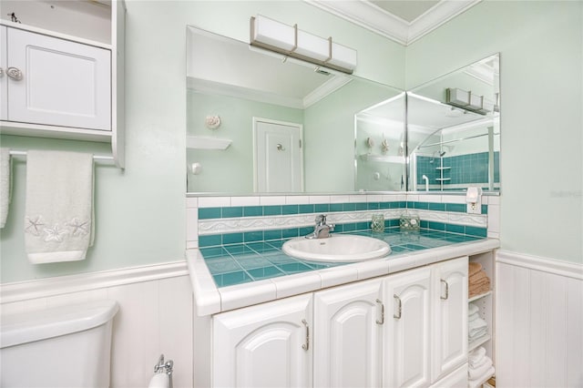 bathroom featuring vanity, an enclosed shower, toilet, and ornamental molding