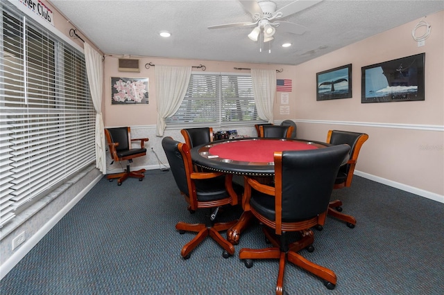 carpeted dining room featuring ceiling fan and a textured ceiling