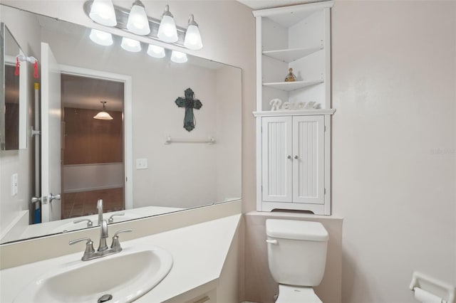 bathroom featuring vanity and toilet