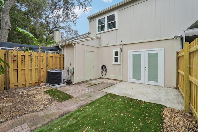 rear view of property featuring central AC unit, french doors, and a patio