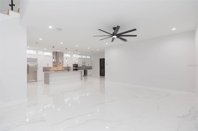 unfurnished living room with ceiling fan