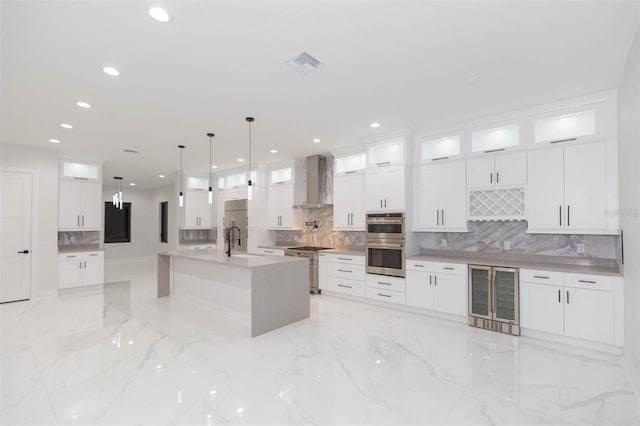 kitchen featuring white cabinets, wall chimney range hood, and wine cooler