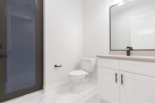 bathroom with toilet and vanity