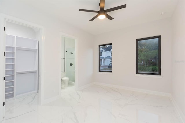 unfurnished bedroom featuring ensuite bathroom and ceiling fan