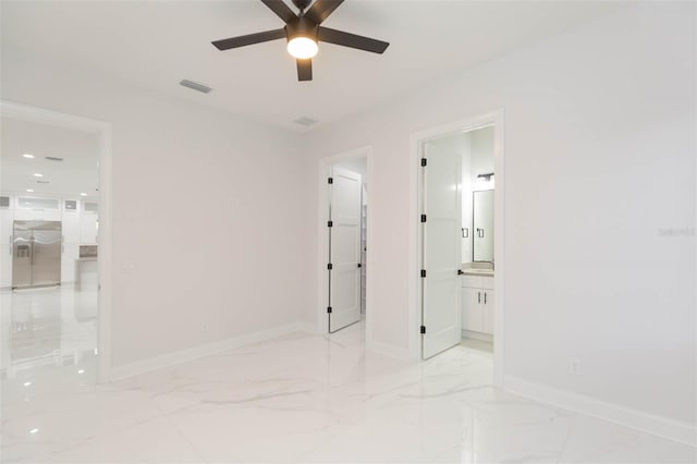 unfurnished bedroom with stainless steel built in fridge, ceiling fan, and connected bathroom