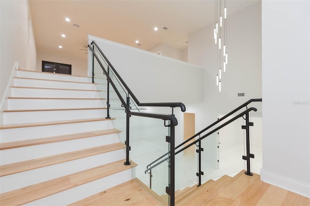 stairway with hardwood / wood-style floors