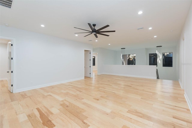 empty room with light wood-type flooring and ceiling fan