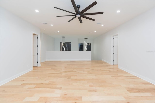 unfurnished room with ceiling fan and light hardwood / wood-style flooring