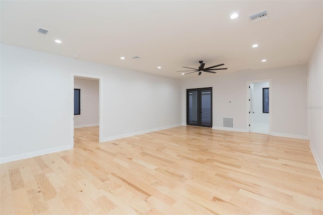 empty room featuring ceiling fan and light hardwood / wood-style flooring