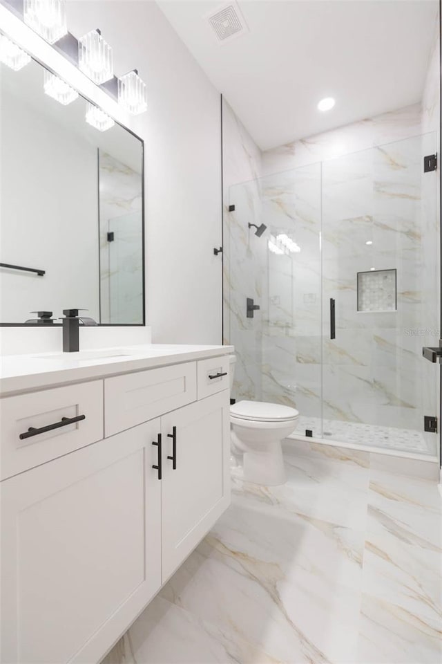 bathroom featuring toilet, an enclosed shower, and vanity