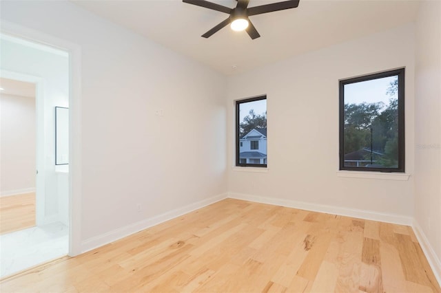 unfurnished room featuring light wood-type flooring and ceiling fan