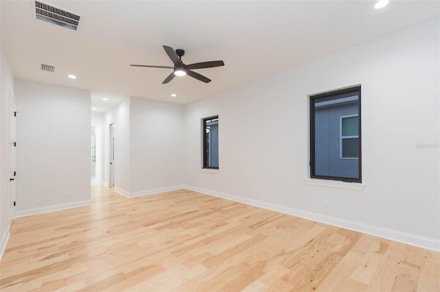 empty room featuring ceiling fan and light hardwood / wood-style flooring