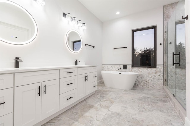 bathroom featuring tile walls, plus walk in shower, and vanity