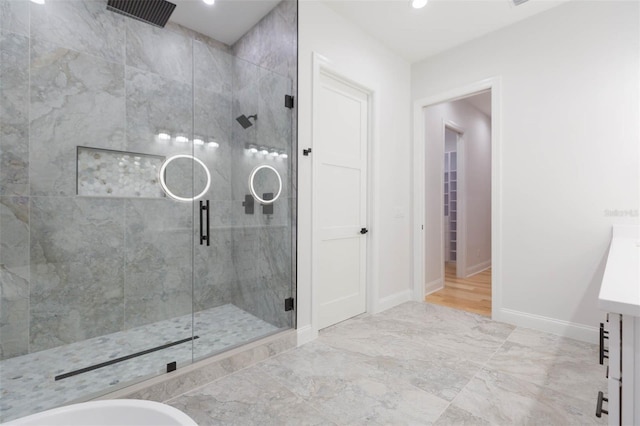 bathroom with walk in shower and vanity