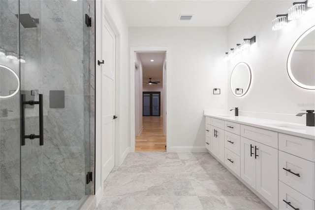 bathroom featuring ceiling fan, walk in shower, and vanity