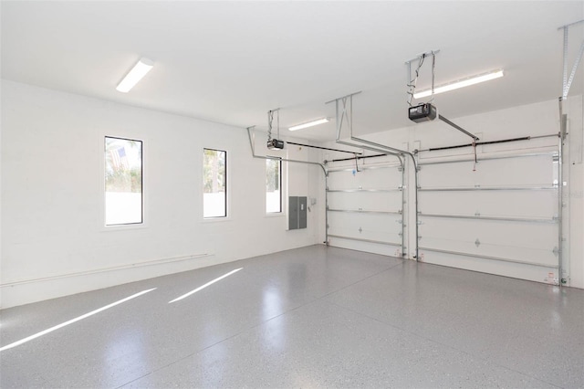 garage featuring electric panel and a garage door opener