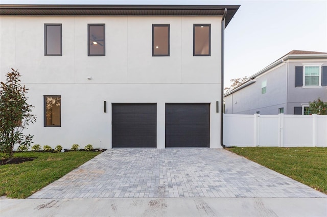 view of front of home with a front yard and a garage