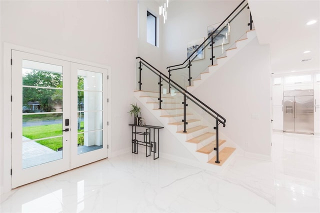 716 S Lois Ave, Tampa, FL 33609 - entryway featuring stairs, french doors, marble tiled floors, baseboards, and a high ceiling