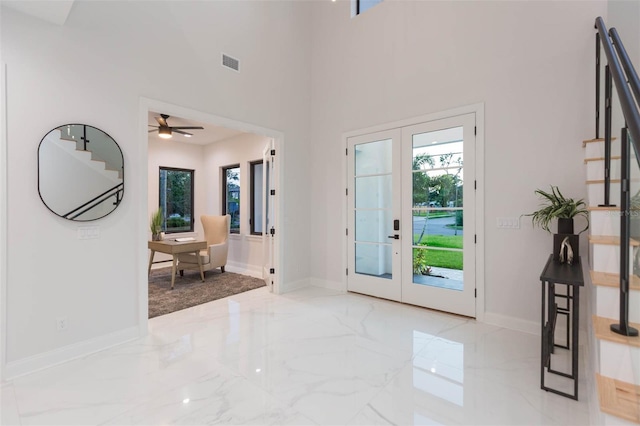 716 S Lois Ave, Tampa, FL 33609 - foyer entrance with healthy amount of natural light, marble tiled floors, and french doors