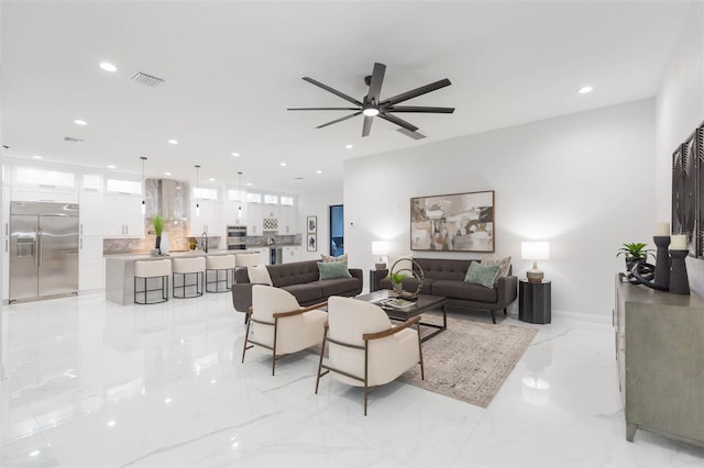 716 S Lois Ave, Tampa, FL 33609 - living room with light marble finish floors, a ceiling fan, and recessed lighting