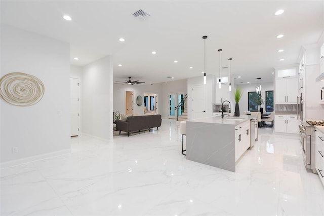 716 S Lois Ave, Tampa, FL 33609 - kitchen with a sink, white cabinets, recessed lighting, open floor plan, and ceiling fan