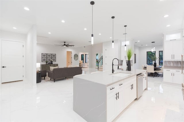 716 S Lois Ave, Tampa, FL 33609 - kitchen with a sink, stainless steel dishwasher, light marble finish floors, white cabinetry, and recessed lighting