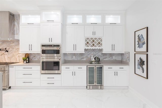 716 S Lois Ave, Tampa, FL 33609 - kitchen with beverage cooler, wall chimney exhaust hood, stainless steel double oven, light marble finish flooring, and light countertops