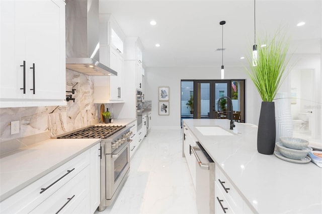716 S Lois Ave, Tampa, FL 33609 - kitchen with stainless steel appliances, wall chimney exhaust hood, a sink, tasteful backsplash, and french doors
