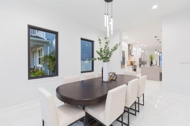 716 S Lois Ave, Tampa, FL 33609 - dining room featuring light marble finish flooring, baseboards, and recessed lighting