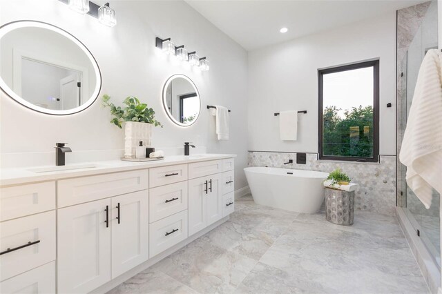 716 S Lois Ave, Tampa, FL 33609 - bathroom featuring double vanity, a shower stall, marble finish flooring, a freestanding bath, and recessed lighting