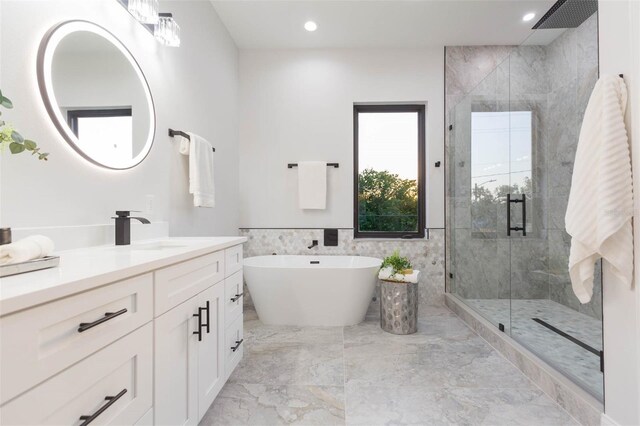 716 S Lois Ave, Tampa, FL 33609 - bathroom featuring a stall shower, vanity, marble finish flooring, a freestanding bath, and recessed lighting