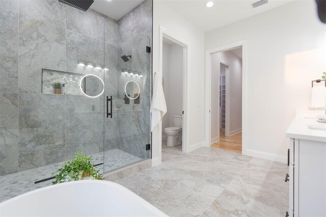 716 S Lois Ave, Tampa, FL 33609 - bathroom with a shower stall, toilet, a freestanding bath, vanity, and baseboards