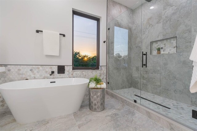 716 S Lois Ave, Tampa, FL 33609 - full bathroom with a stall shower, marble finish floors, a freestanding bath, and tile walls