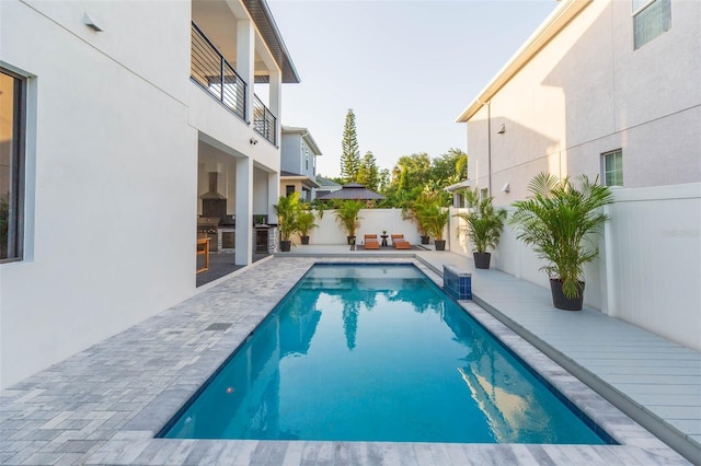 716 S Lois Ave, Tampa, FL 33609 - view of pool with a fenced backyard, an outdoor bar, exterior kitchen, and a patio area