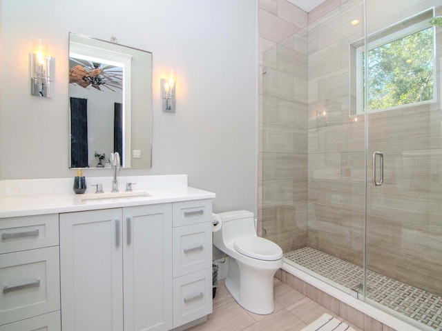 bathroom featuring tile patterned floors, vanity, toilet, and walk in shower